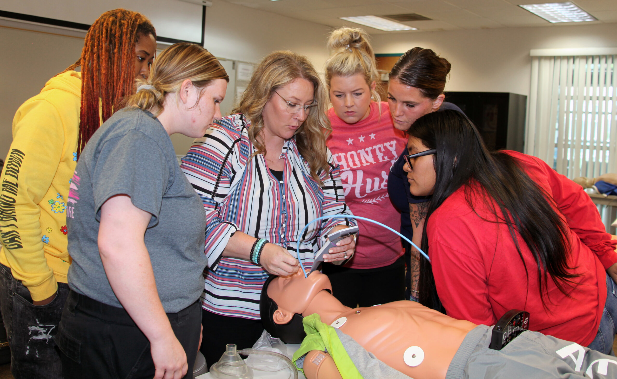GNTC Paramedicine program Director Nina Piatt (center) demonstrates on a manikin how to intubate a patient as students (from left) R’Neshia Kenmoore, Savannah Calhoun, Paige Hall, Katie Deperro and Elia Lucas watch.