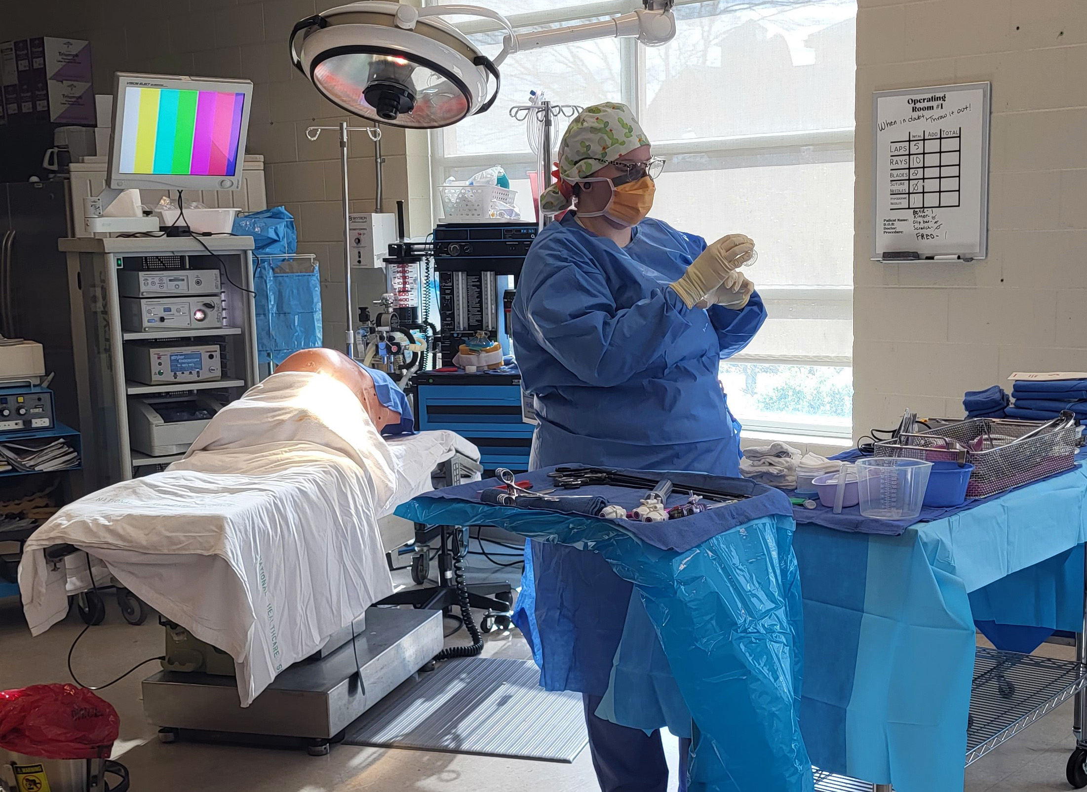 GNTC graduate Hanna Leamon finishes getting her table ready before she sets up for a mock surgery case in the lab.