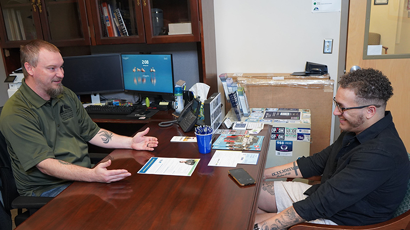 Josh Hickman, Military-Connected Services coordinator at GNTC (left), congratulates DVSS recipient Christian Cooke.