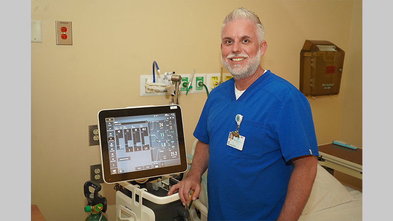 
GNTC alum Jay Shedd, system director of Respiratory Therapy, Sleep Lab and Neurodiagnostic at Atrium Health Floyd, poses with a ventilator.
